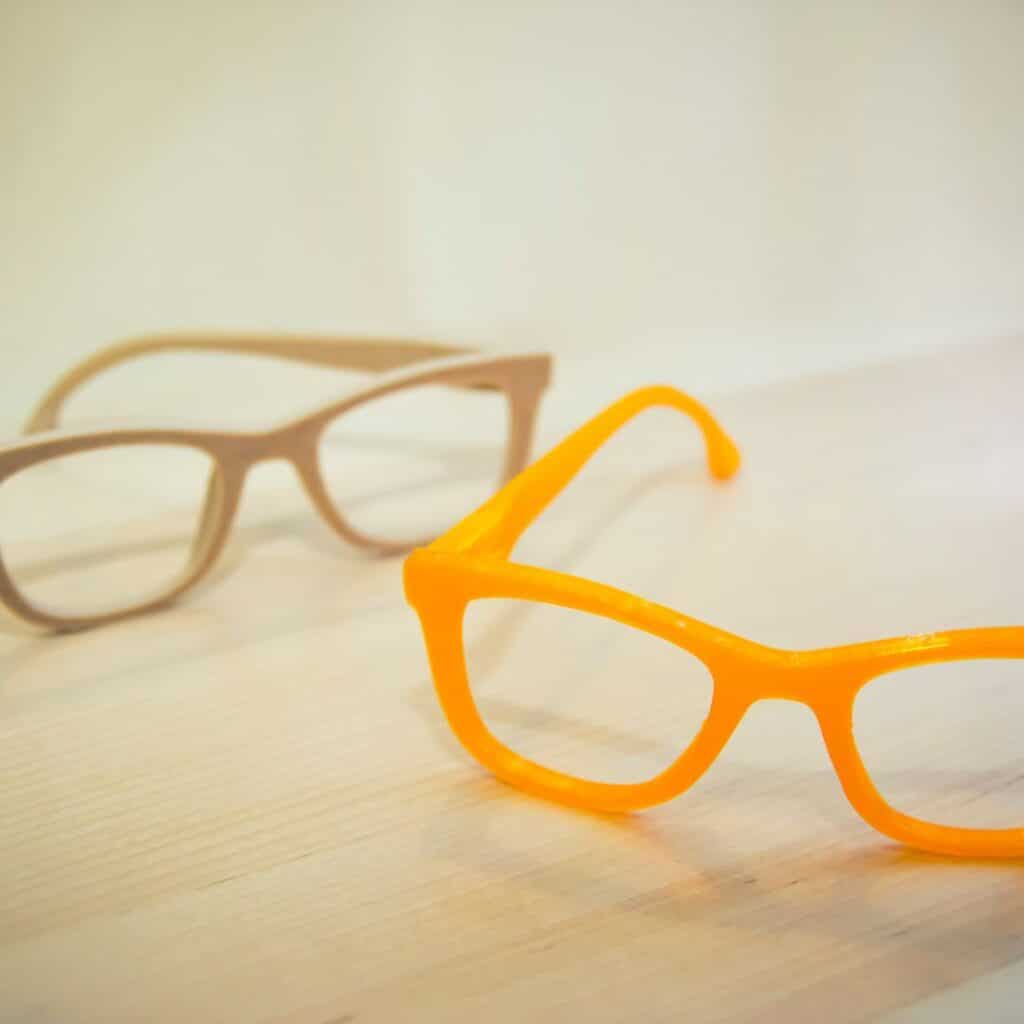 Two pairs of eyeglass frames that have been 3D printed.