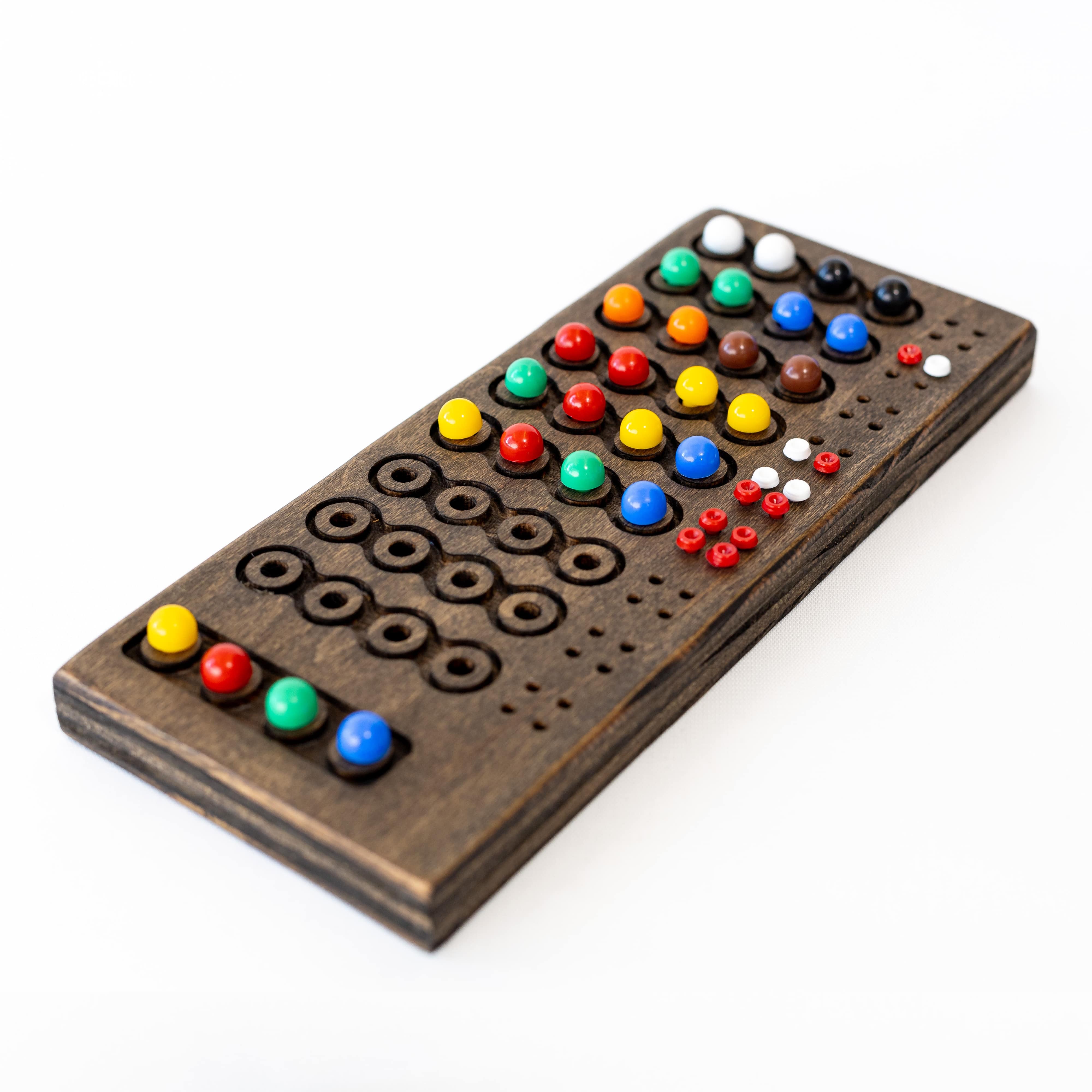 A wooden game board with colorful ball pieces.