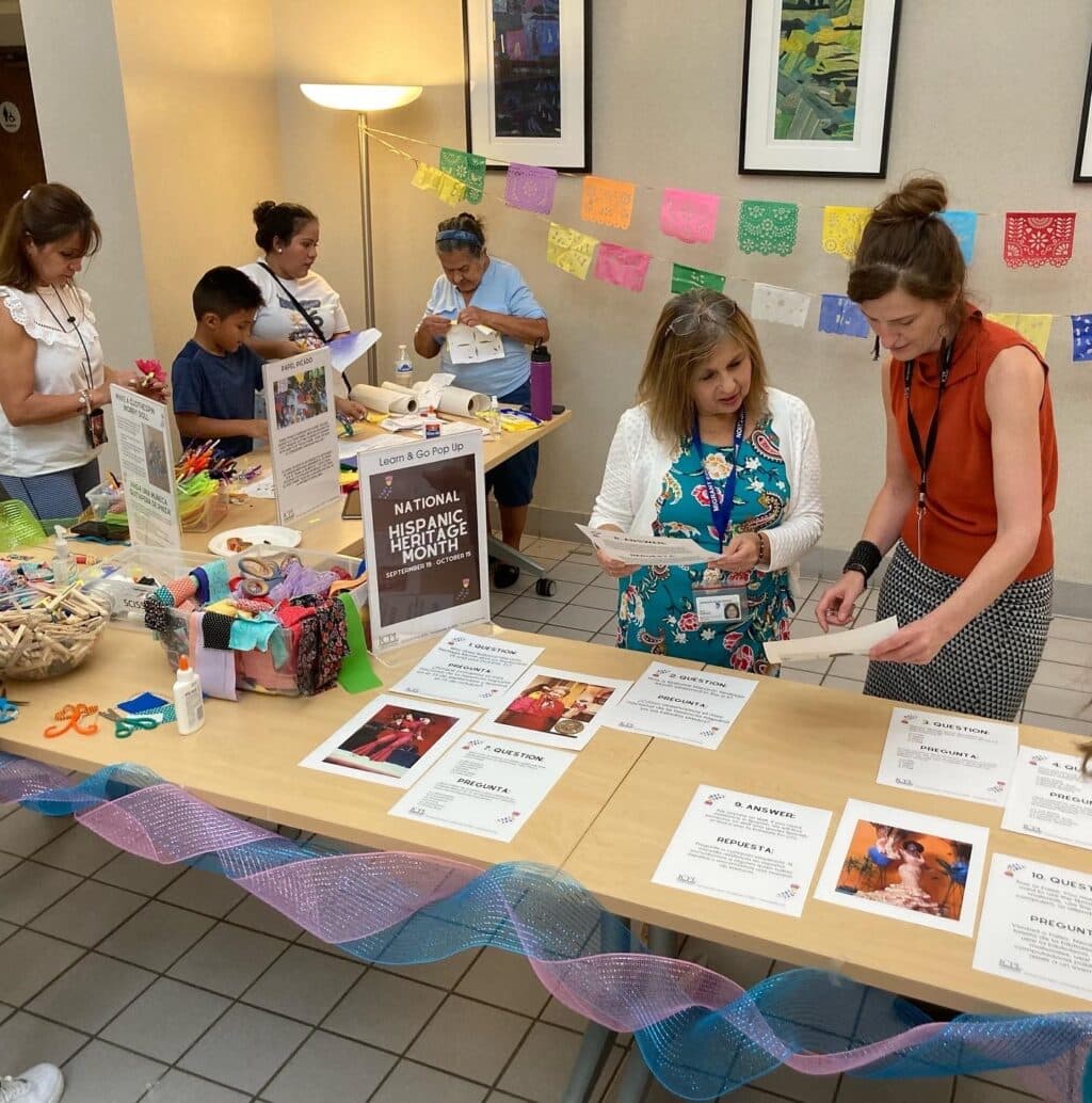 Participants make crafts and look at information at a Hispanic Heritage Month program at the library.
