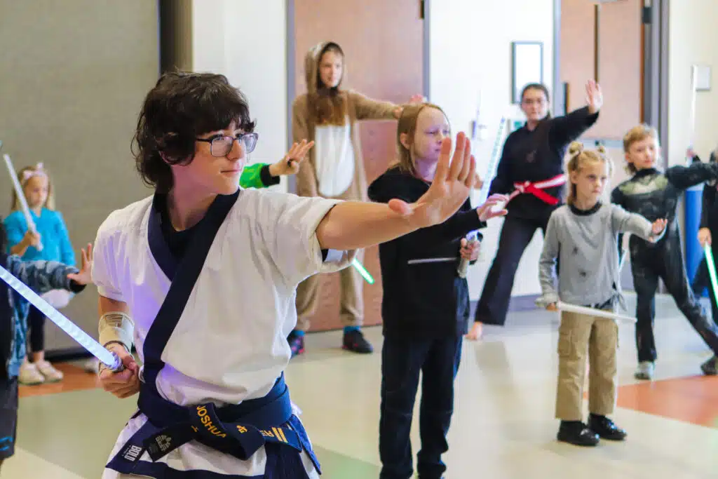 Children in the 2022 light saber training class with Lion's Pride Martial Arts