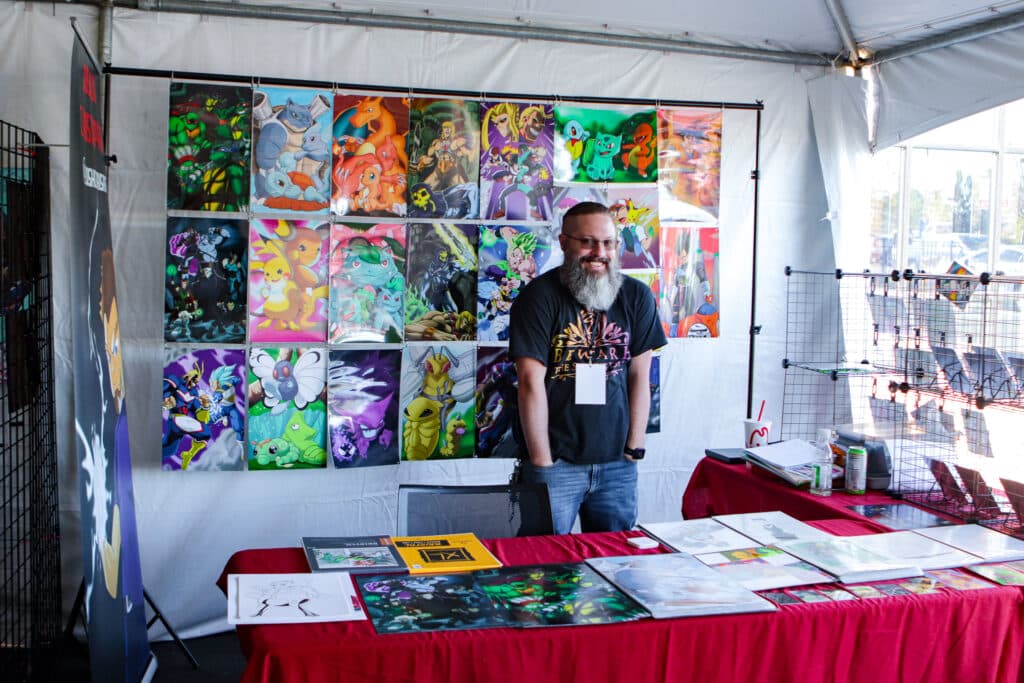 A vendor from the 2022 Comic Surge with his artwork.