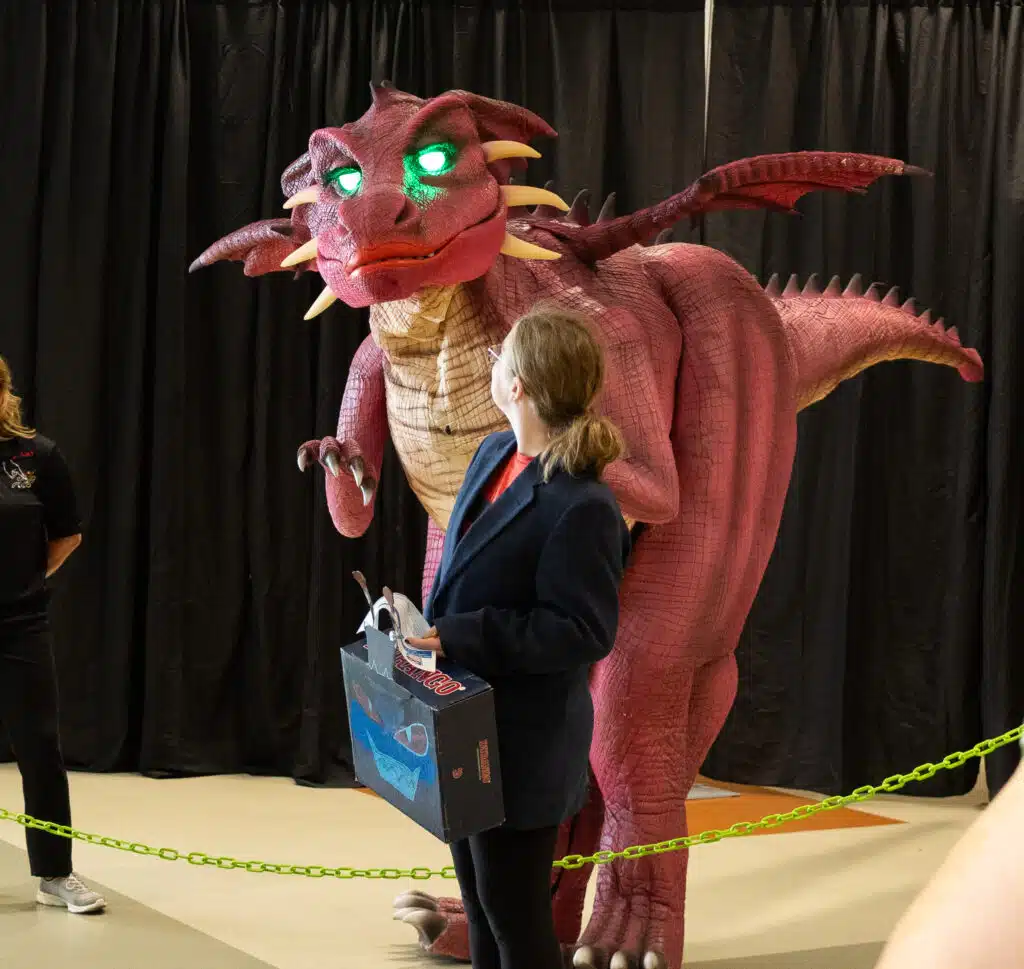 A teen looks back at a costumed Jabberwock.