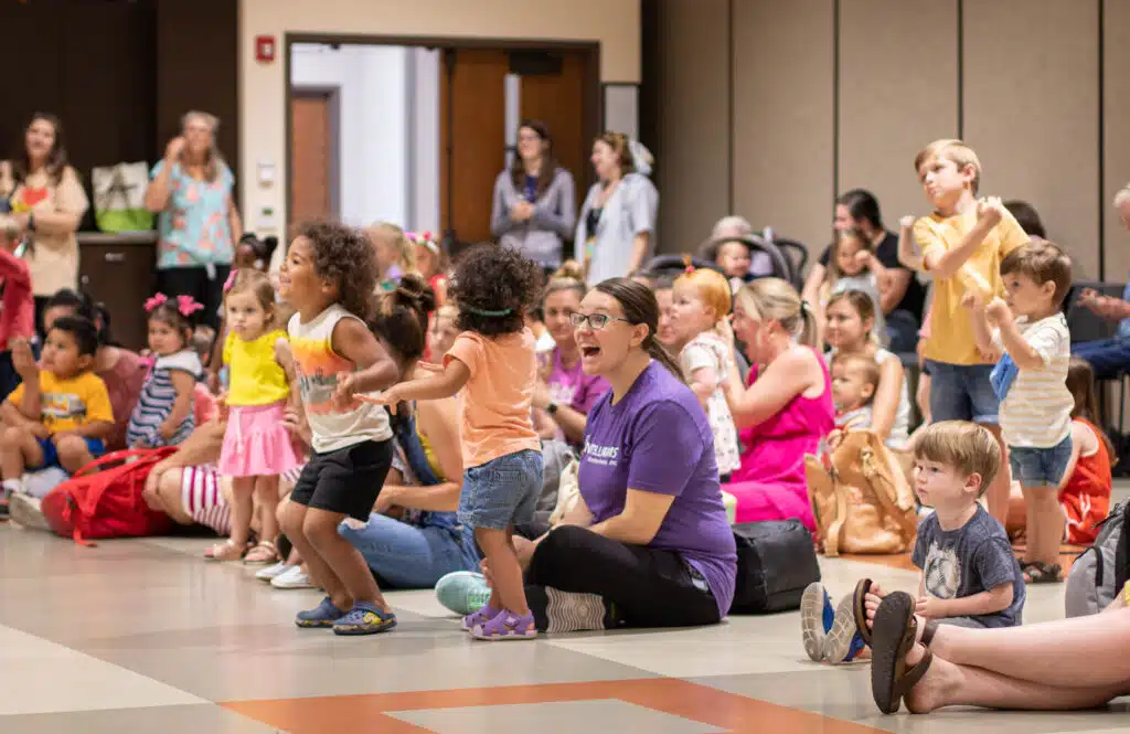 Children and their grownups enjoy a children's program at the library.