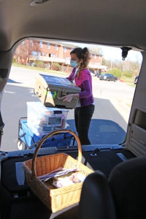 The Adult Outreach Librarian loading books into a JCPL van.